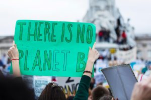 Protestor holding a sign reading 'There is no Planet B' at a climate protest