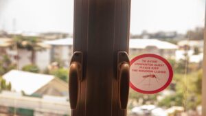 Mosquito warning sticker on window